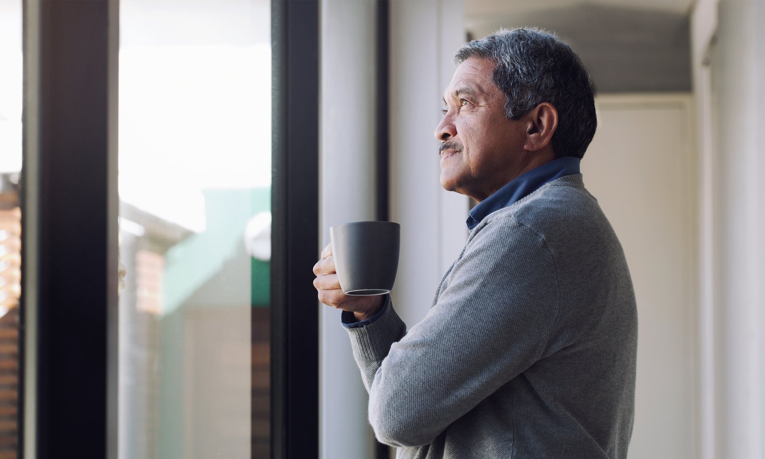 There's always something to look forward to Shot of a senior man drinking coffee and looking thoughtfully out of a window