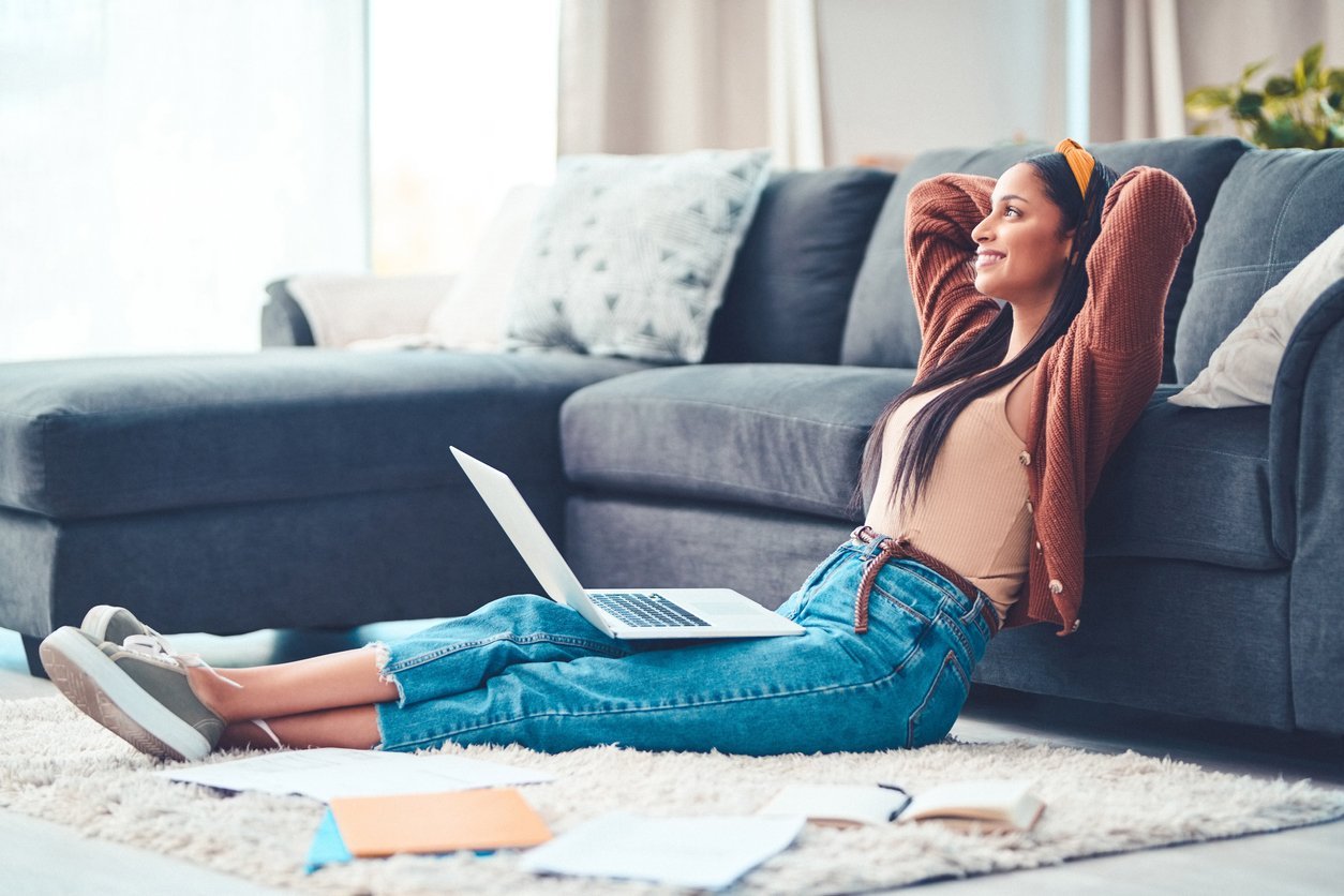 To live your best, find your balance Shot of a young woman relaxing while working in the living room at home